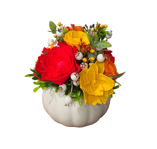 Autumn Cheer red, orange and yellow wood flower arrangement with berries and greenery in a white ceramic pumpkin.