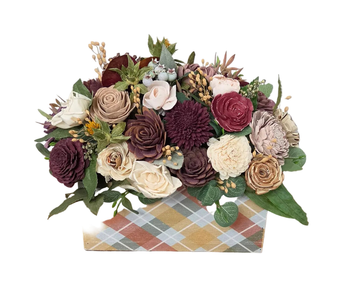 Autumn Heirloom wood flower arrangement with burgundy, plum, blush and ivory flowers, greenery and botanical accents in a fall plaid planter.