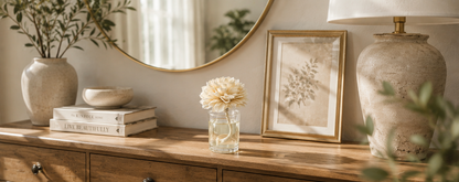 Painted Petals flower diffuser with natural wood flower and fragrance oil styled on a warm wood console table in a neutral home.