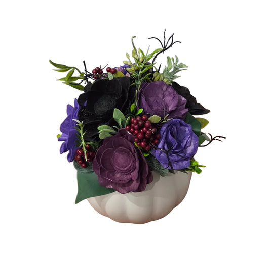 Back view of Witching Hour purple and black wood flower arrangement with berries and greenery in a white ceramic pumpkin.